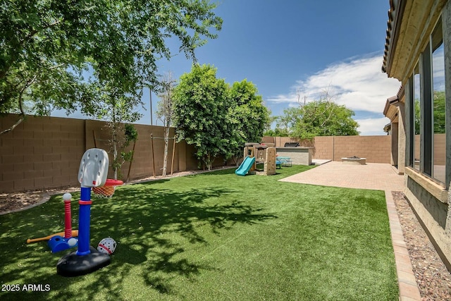 view of yard featuring a patio area and a playground