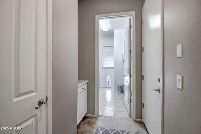 corridor featuring light tile patterned floors