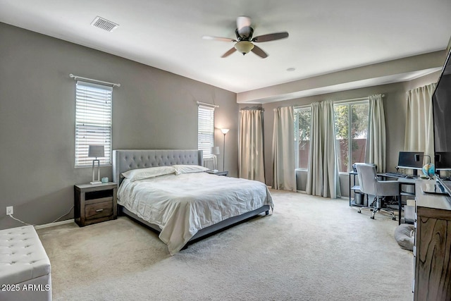 carpeted bedroom featuring ceiling fan and multiple windows