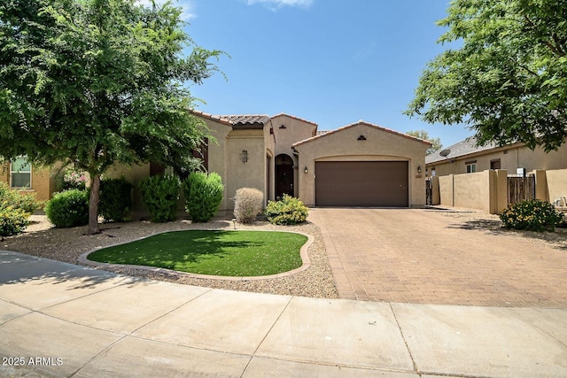 mediterranean / spanish-style house with a garage