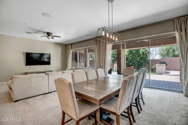 carpeted dining area featuring ceiling fan