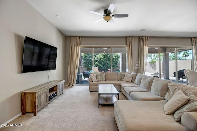 living room with ceiling fan and light colored carpet