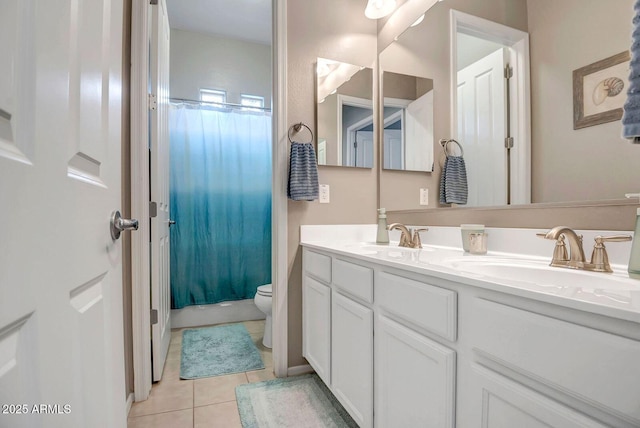 bathroom with toilet, vanity, tile patterned floors, and curtained shower