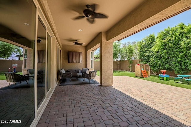 view of patio featuring a playground, ceiling fan, and an outdoor hangout area