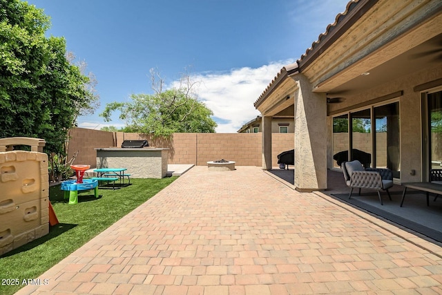 view of patio / terrace featuring an outdoor fire pit