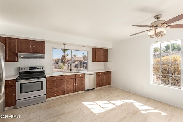 kitchen with stainless steel appliances, sink, and backsplash