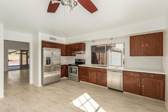 kitchen with sink, backsplash, ceiling fan, and appliances with stainless steel finishes