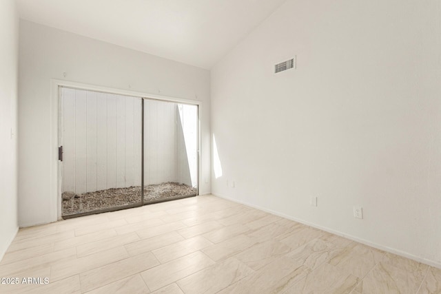 unfurnished bedroom with lofted ceiling and a closet