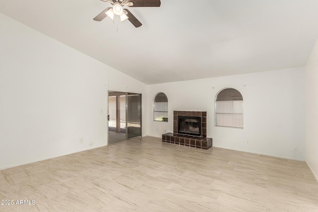 unfurnished living room with ceiling fan, lofted ceiling, and a fireplace