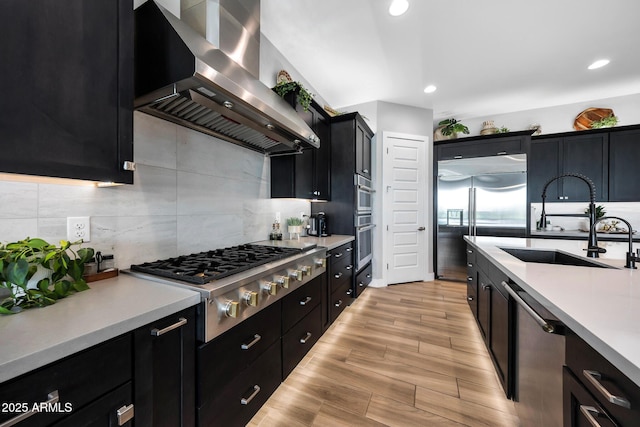 2037 E Fallen Leaf Ln, Phoenix, AZ 85024 - kitchen featuring wall chimney exhaust hood, stainless steel appliances, dark cabinets, light countertops, and recessed lighting