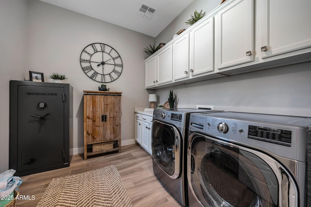2037 E Fallen Leaf Ln, Phoenix, AZ 85024 - laundry room featuring washing machine and clothes dryer, cabinet space, and light wood finished floors