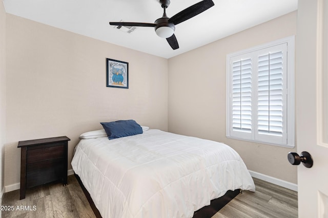 bedroom featuring wood-type flooring and ceiling fan