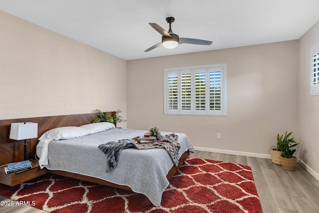 bedroom with light hardwood / wood-style floors and ceiling fan