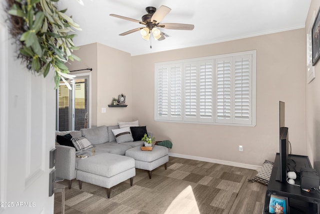 living room featuring crown molding, hardwood / wood-style floors, and ceiling fan