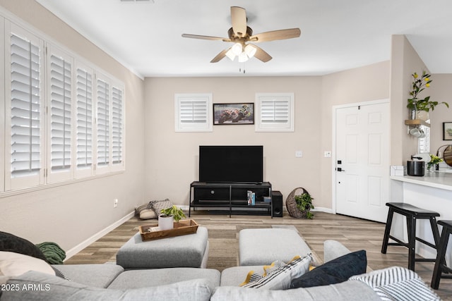 living room with ceiling fan and light hardwood / wood-style floors