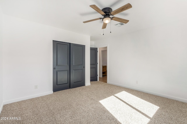 unfurnished bedroom featuring carpet flooring, ceiling fan, and a closet