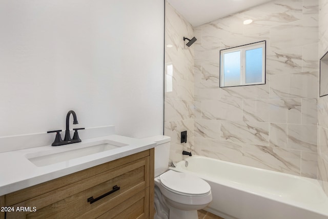 full bathroom featuring toilet, vanity, and tiled shower / bath