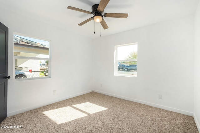 empty room featuring carpet floors and ceiling fan