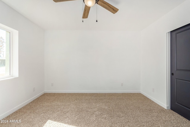 carpeted empty room featuring ceiling fan