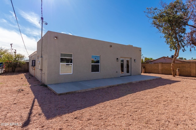 back of property with a patio and french doors