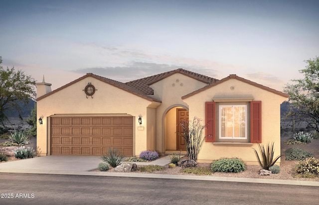 mediterranean / spanish home featuring driveway, an attached garage, a tiled roof, and stucco siding