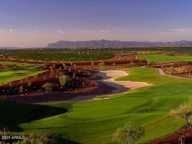 surrounding community with golf course view and a mountain view