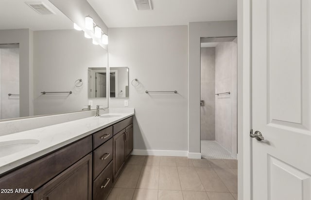 bathroom with walk in shower, a sink, and visible vents