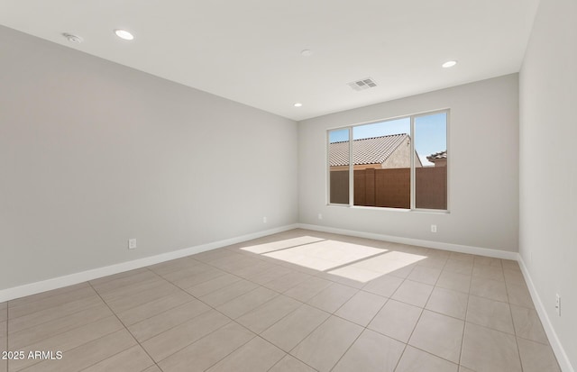 spare room featuring recessed lighting, visible vents, and baseboards