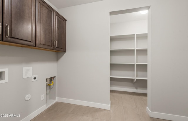 laundry area featuring cabinet space, baseboards, gas dryer hookup, washer hookup, and electric dryer hookup