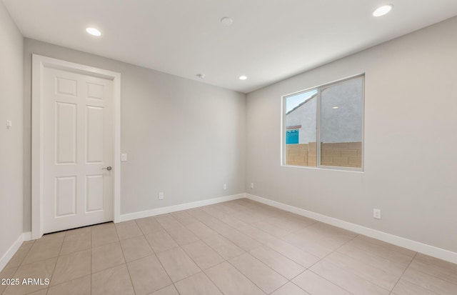 unfurnished room featuring baseboards and recessed lighting