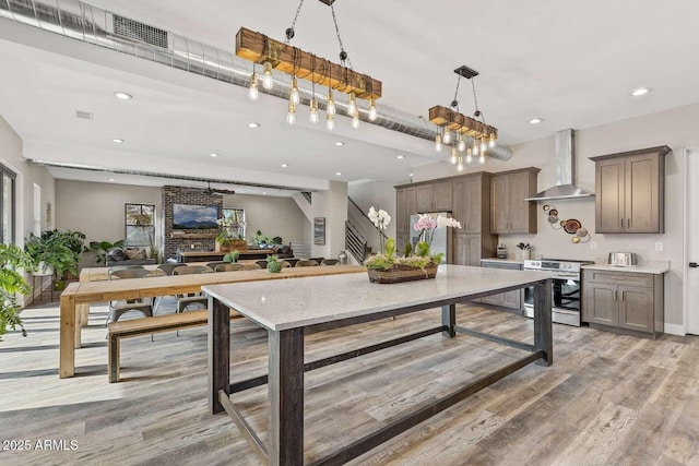 301 S O Leary St, Flagstaff, AZ 86001 - kitchen with visible vents, wall chimney exhaust hood, stainless steel electric stove, light wood-style floors, and recessed lighting