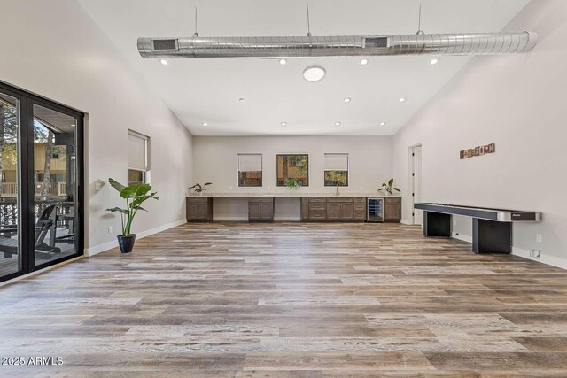301 S O Leary St, Flagstaff, AZ 86001 - unfurnished living room with a high ceiling, baseboards, and wood finished floors