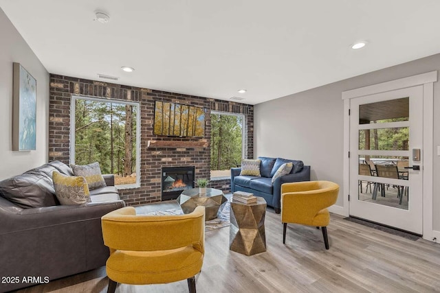 301 S O Leary St, Flagstaff, AZ 86001 - living room featuring light wood finished floors, visible vents, brick wall, a brick fireplace, and recessed lighting