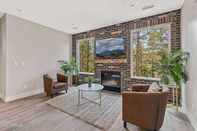 301 S O Leary St, Flagstaff, AZ 86001 - sitting room featuring baseboards, a fireplace, visible vents, and wood finished floors