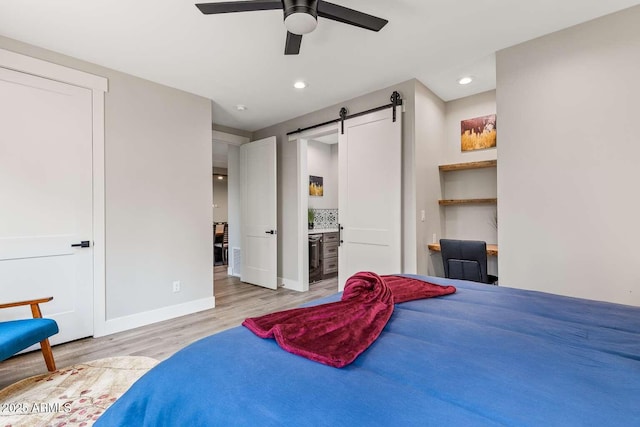 301 S O Leary St, Flagstaff, AZ 86001 - bedroom featuring recessed lighting, baseboards, light wood finished floors, and a barn door