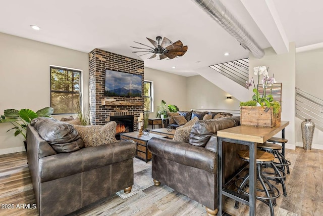 301 S O Leary St, Flagstaff, AZ 86001 - living room featuring a brick fireplace, ceiling fan, baseboards, and wood finished floors