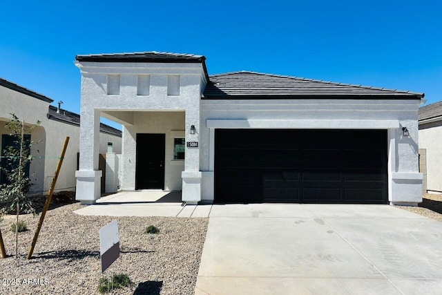 5084 E Umber Rd, San Tan Valley, AZ 85143 - view of front of home featuring a garage, concrete driveway, a tiled roof, and stucco siding