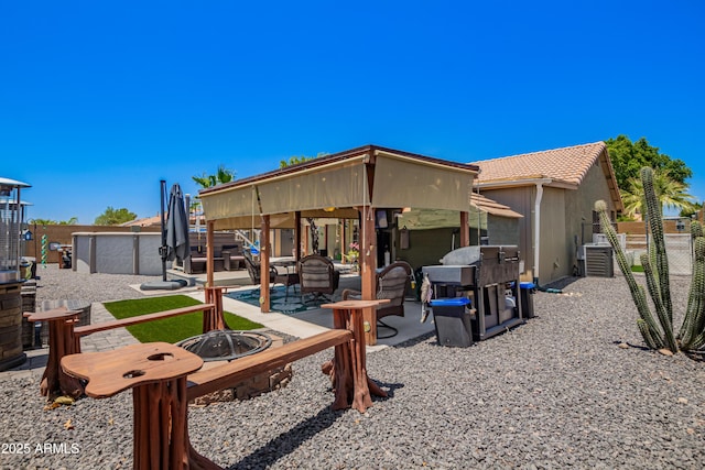 863 W 14th Ave, Apache Junction, AZ 85120 - back of property with a fire pit, a fenced backyard, a patio area, and a gazebo