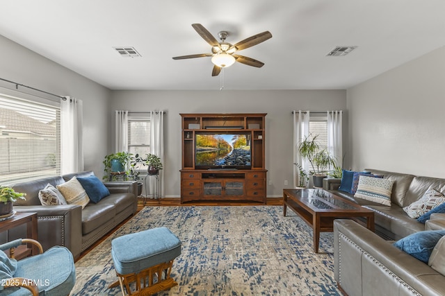 living room featuring ceiling fan and light hardwood / wood-style floors