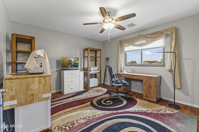 office area with ceiling fan and dark hardwood / wood-style floors