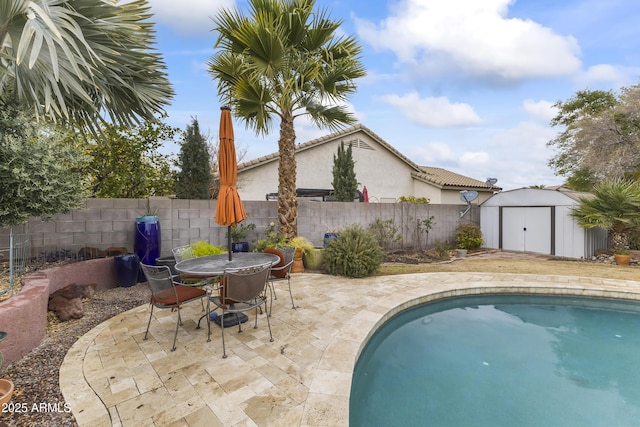 view of swimming pool featuring a storage shed and a patio area