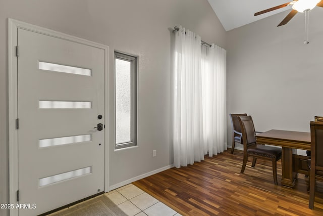 entryway with vaulted ceiling, plenty of natural light, ceiling fan, and light wood-type flooring