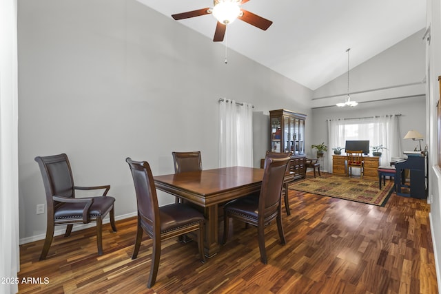 dining room featuring dark hardwood / wood-style floors, ceiling fan with notable chandelier, and high vaulted ceiling