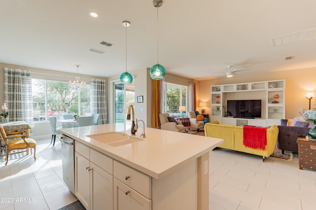 kitchen featuring ceiling fan with notable chandelier, an island with sink, a healthy amount of sunlight, and sink