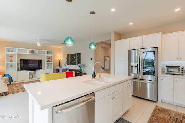 kitchen featuring sink, hanging light fixtures, a center island with sink, appliances with stainless steel finishes, and ceiling fan