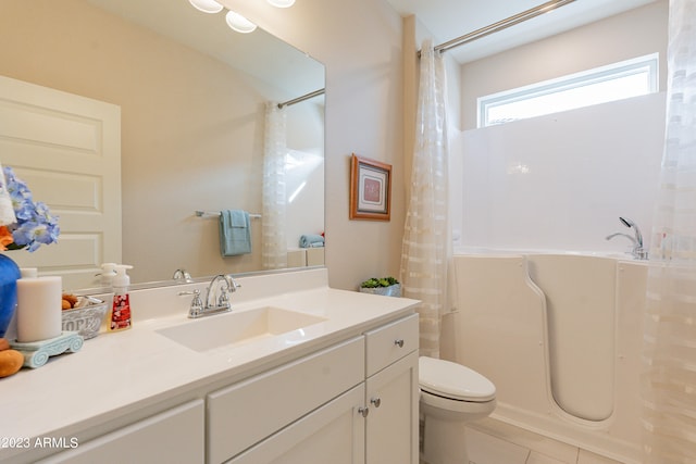 full bathroom with shower / bath combo with shower curtain, tile patterned floors, vanity, and toilet