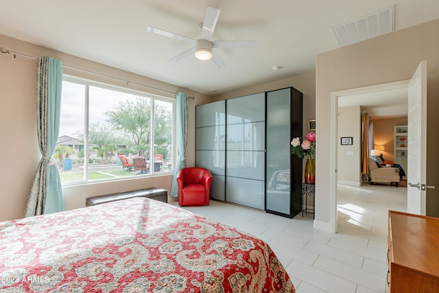 bedroom featuring ceiling fan and light tile patterned flooring