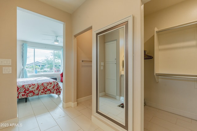 bathroom with ceiling fan and tile patterned floors