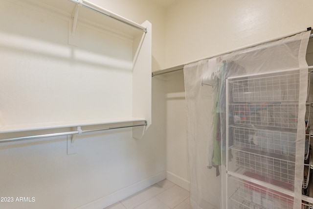 walk in closet featuring light tile patterned flooring