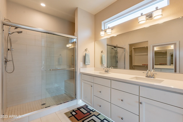 bathroom featuring vanity, an enclosed shower, and tile patterned floors